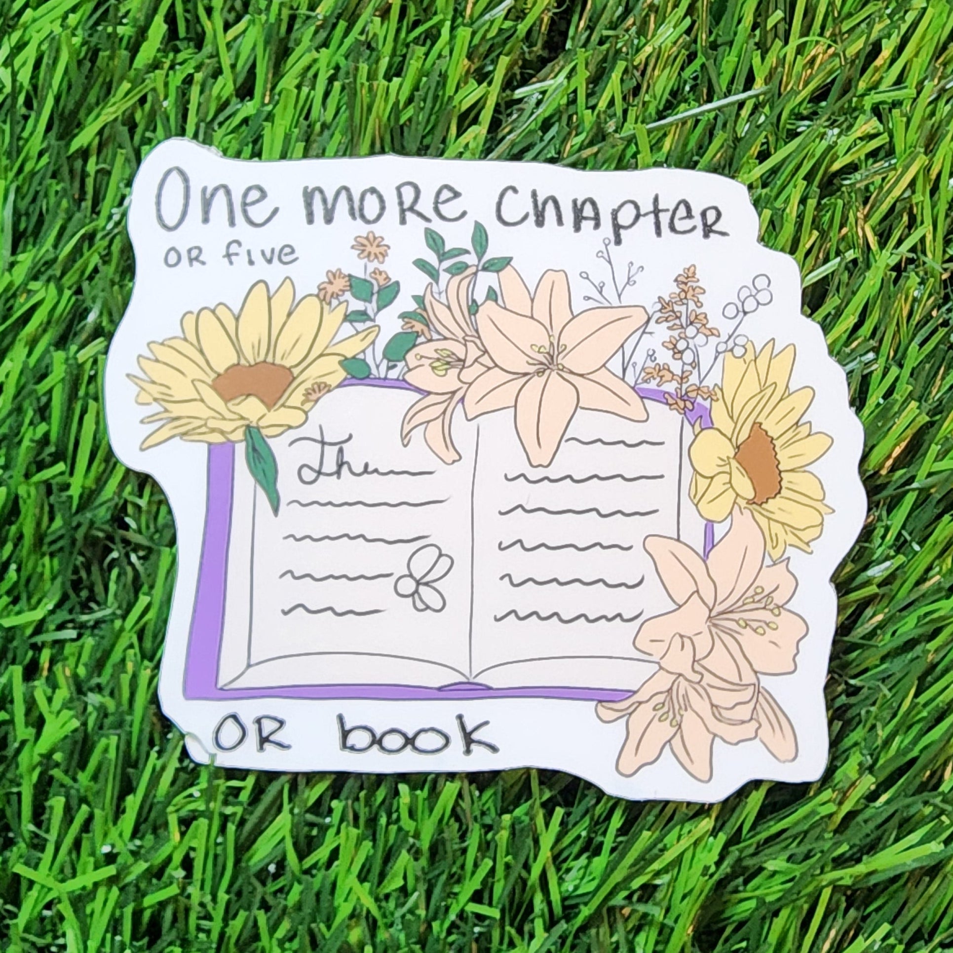 Sticker with floral design and text on grass