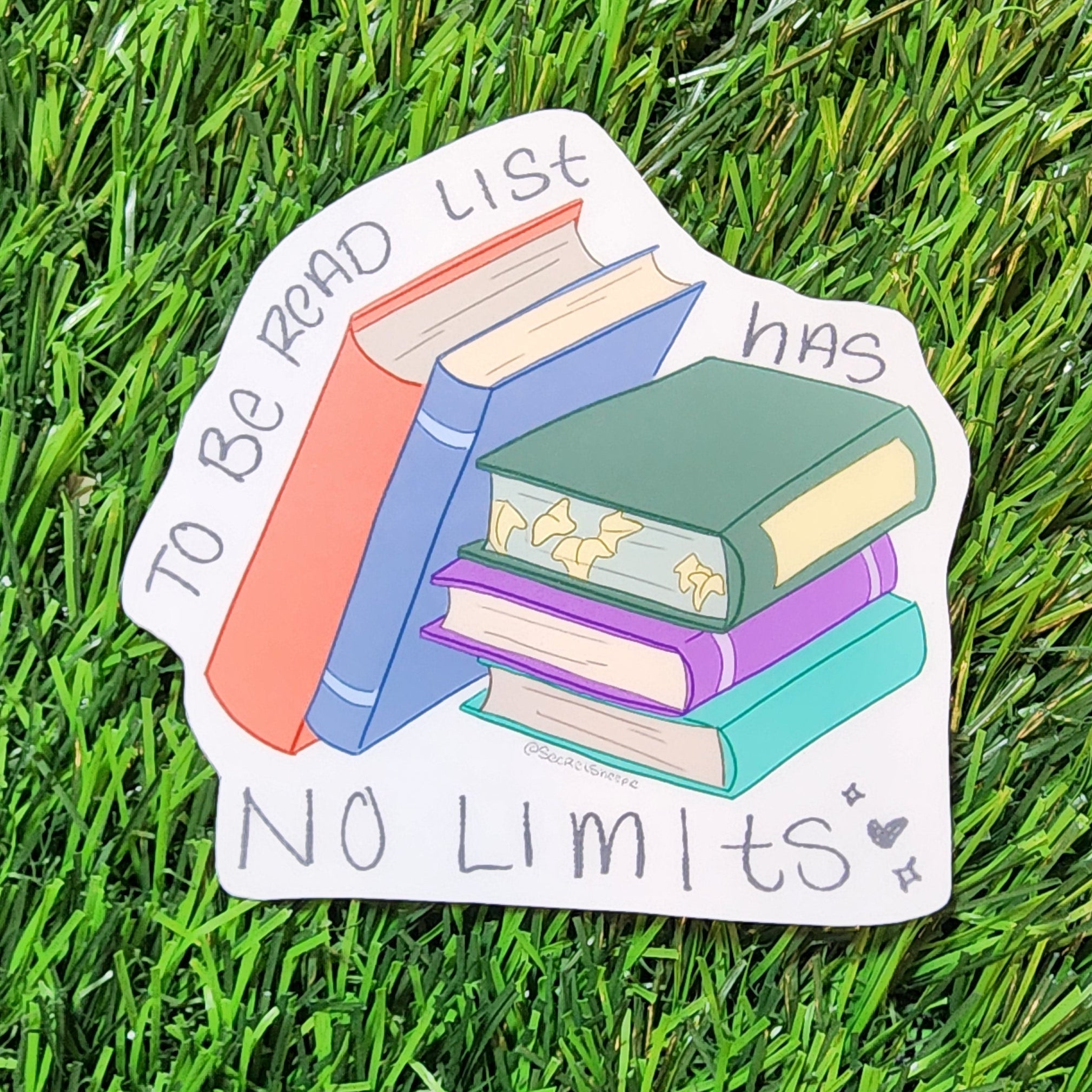 Sticker with books and text on grass